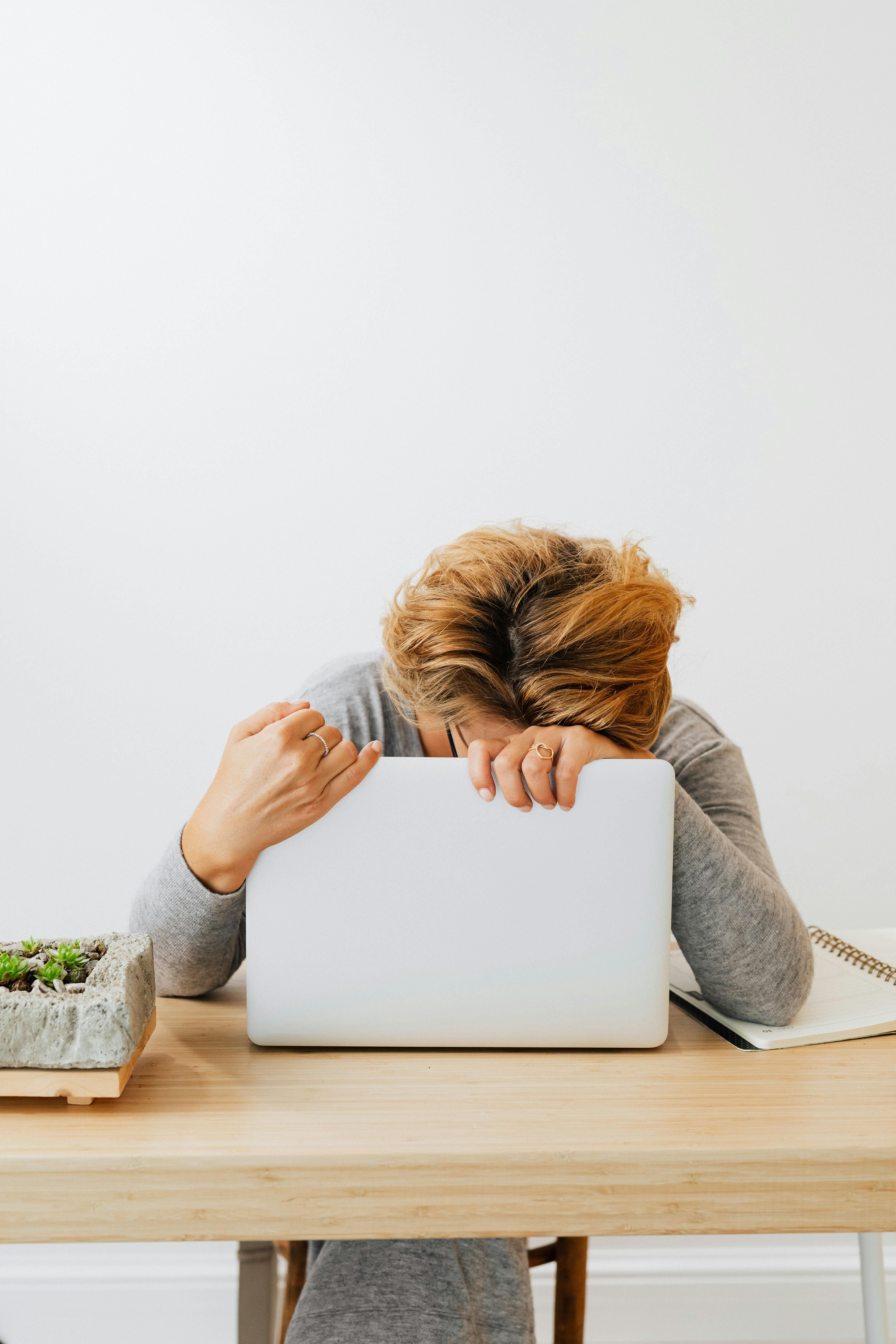 A frustrated blogger looking at a crashed website screen, highlighting the importance of website backup and blog recovery strategies
