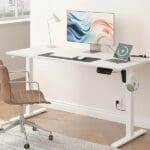A modern home office with an adjustable standing desk